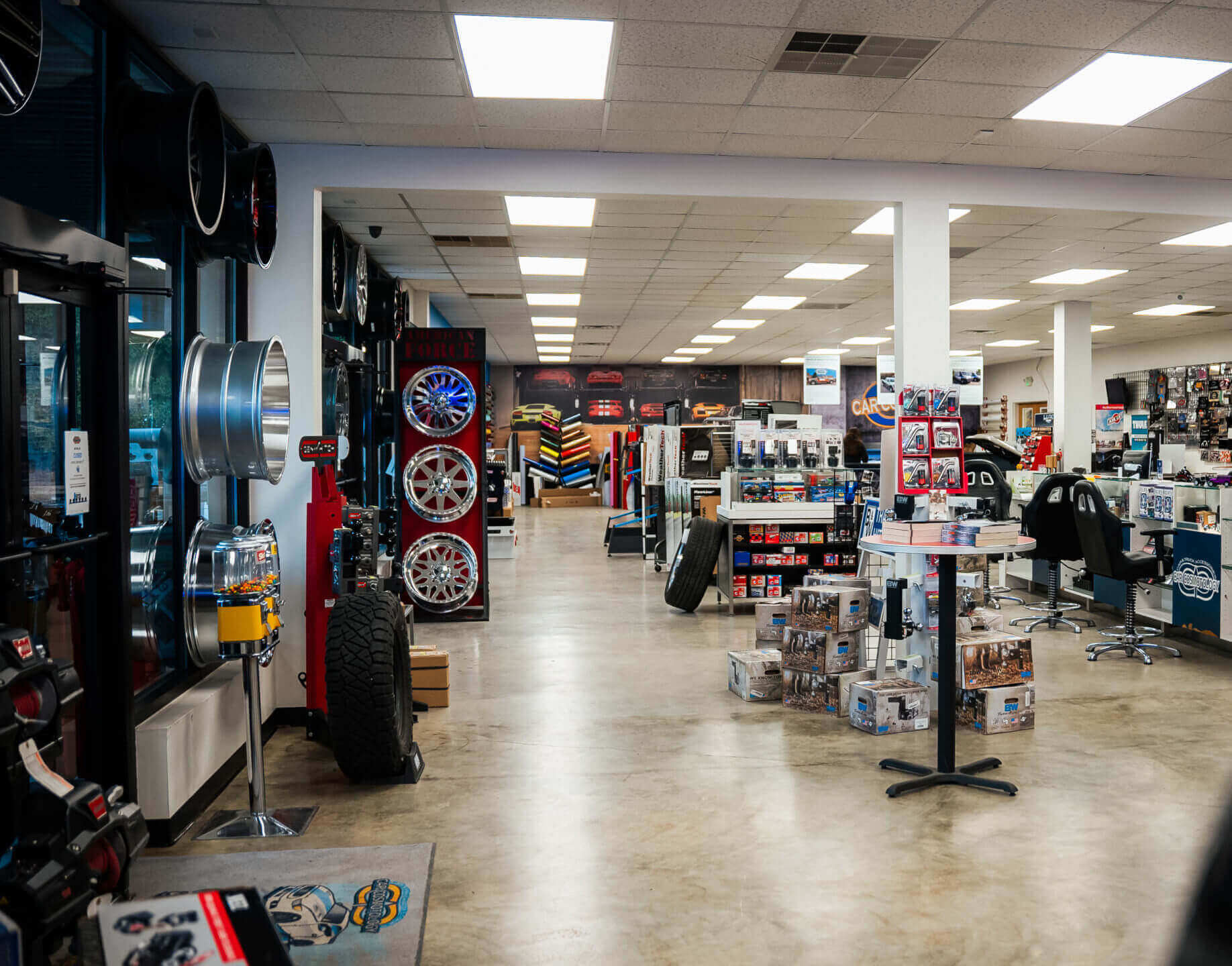 A car shop with many tires and wheels on display.