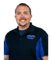 Here’s an alt tag for the image: `Headshot of a smiling man in a polo shirt` Car Dealer Team Member