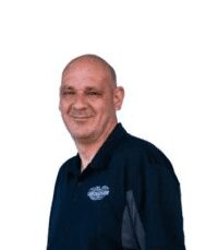 Here’s an 8-word alt tag for the image: Smiling man in dark polo shirt headshot. Car Dealer Team Member